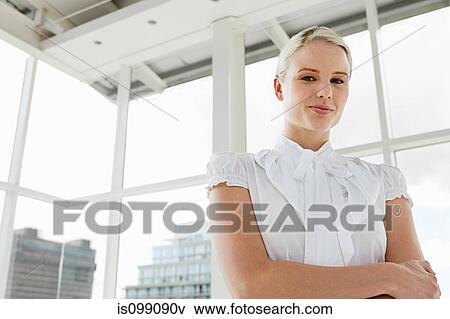 Stock Photo - Businesswoman wearing white blouse, portrait. Fotosearch