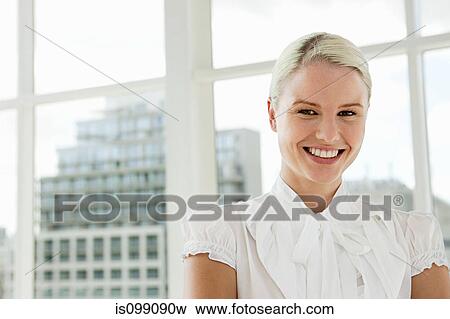 Stock Photo - Businesswoman wearing white blouse, portrait. Fotosearch