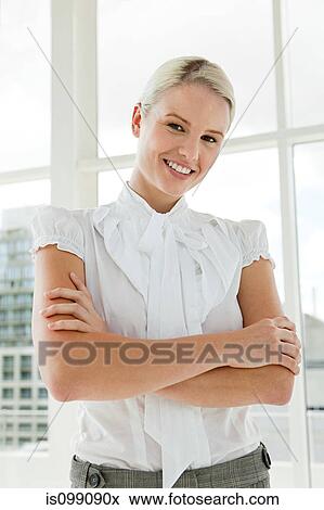 Stock Photo - Businesswoman wearing white blouse, portrait. Fotosearch