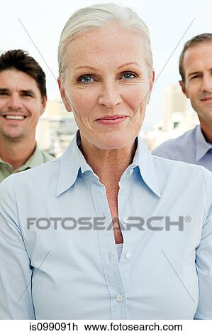 Three businesspeople, focus on woman View Large Photo Image Stock Image - Three businesspeople, focus on woman. Fotosearch