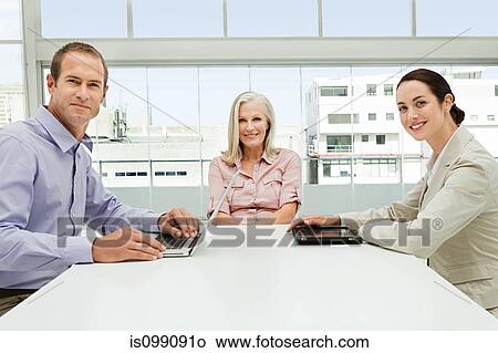 Three businesspeople meeting in office View Large Photo Image Picture - Three businesspeople meeting in office. Fotosearch