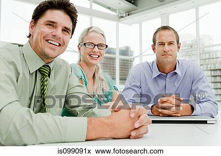 Three businesspeople meeting in office View Large Photo Image Stock Photo - Three businesspeople meeting in office. Fotosearch