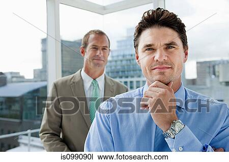 Two businessmen in office, portrait View Large Photo Image Stock Image - Two businessmen in office, portrait. Fotosearch