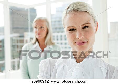 Two businesswomen in office, portrait View Large Photo Image Stock Image - Two businesswomen in office, portrait. Fotosearch