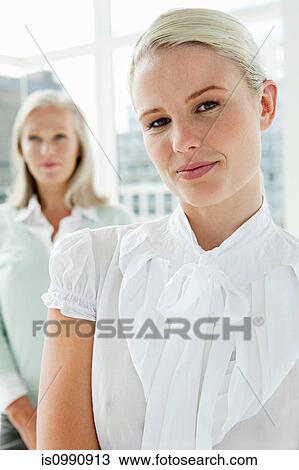 Two businesswomen in office, portrait View Large Photo Image Stock Image - Two businesswomen in office, portrait. Fotosearch