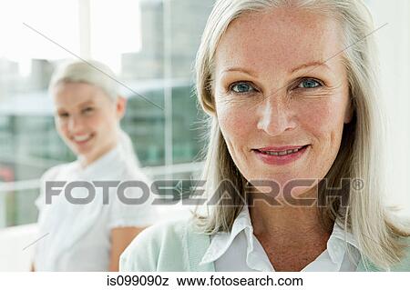 Two businesswomen in office, portrait View Large Photo Image Stock Photo - Two businesswomen in office, portrait. Fotosearch