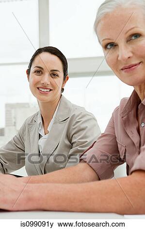 Two businesswomen in office, portrait View Large Photo Image Stock Photo - Two businesswomen in office, portrait. Fotosearch