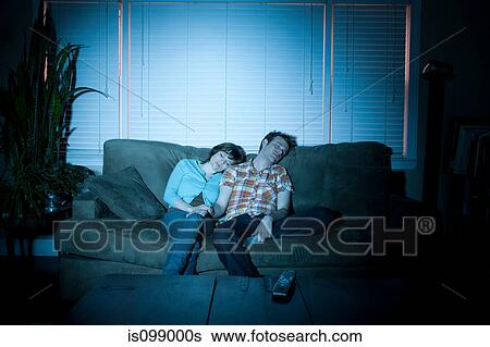 Young couple fallen asleep in front of tv View Large Photo Image Stock Photograph - Young couple fallen asleep in front of tv. Fotosearch