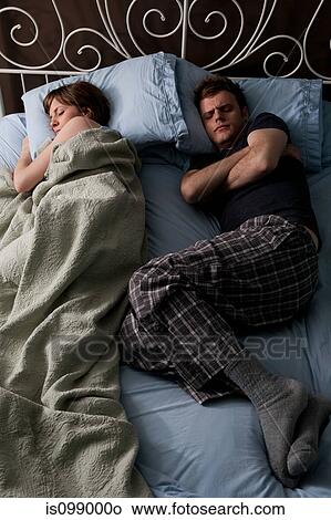 Young stealing blankets from young man View Large Photo Image Picture - Young stealing blankets from young man. Fotosearch