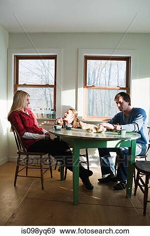 Stock Photo - Family having breakfast. Fotosearch