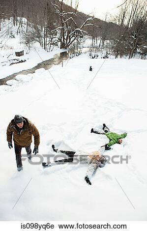 Family making snow angels View Large Photo Image Stock Image - Family making snow angels. Fotosearch