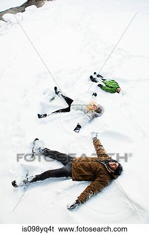 Family making snow angels View Large Photo Image Stock Photograph - Family making snow angels. Fotosearch