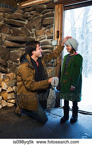Father putting hat on daughter View Large Photo Image Stock Image - Father putting hat on daughter. Fotosearch