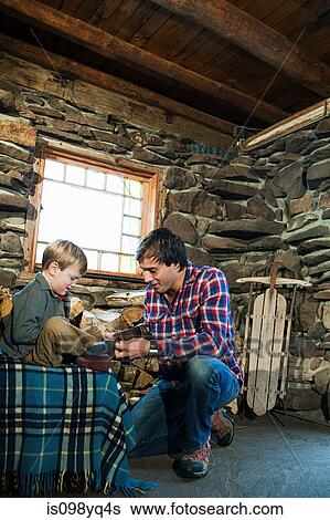 Father putting shoes on son View Large Photo Image Stock Photograph - Father putting shoes on son. Fotosearch
