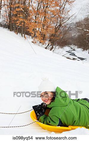 Girl sledging in snow View Large Photo Image Picture - Girl sledging in snow. Fotosearch