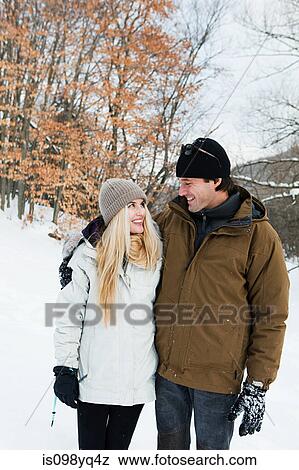 Stock Photo - Mid adult couple in snow. Fotosearch