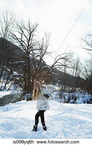 Mid adult woman paying in snow View Large Photo Image Stock Image - Mid adult woman paying in snow. Fotosearch