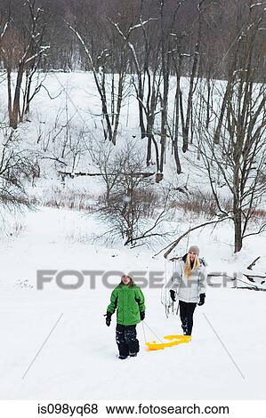 Mother and daughter sledging in snow View Large Photo Image Stock Photo - Mother and daughter sledging in snow. Fotosearch