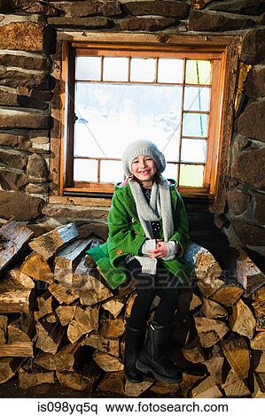 Portrait of girl sitting on logs View Large Photo Image Stock Photography - Portrait of girl sitting on logs. Fotosearch