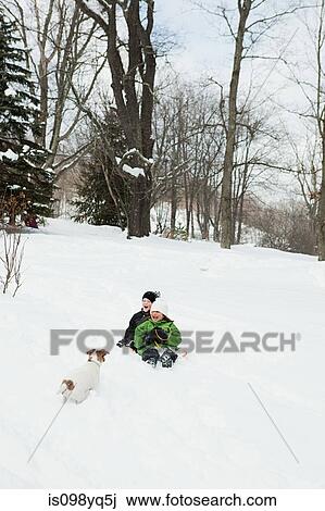 Two children sledging in snow View Large Photo Image Stock Image - Two children sledging in snow. Fotosearch