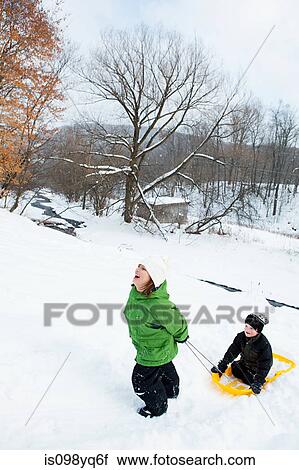 Two children sledging in snow View Large Photo Image Stock Image - Two children sledging in snow. Fotosearch