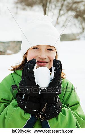 Stock Photography - Young girl holding snowball. Fotosearch