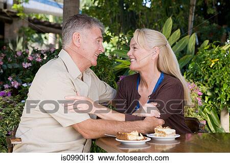Affectionate mature couple in cafe View Large Photo Image Stock Image - Affectionate mature couple in cafe. Fotosearch