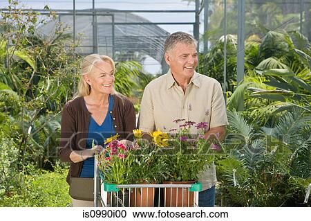 Couple shopping in garden centre View Large Photo Image Stock Image - Couple shopping in garden centre. Fotosearch