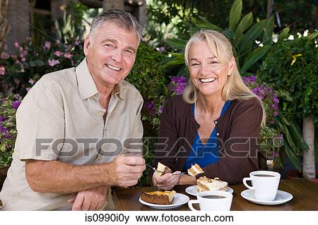 Mature couple having cake View Large Photo Image Stock Photo - Mature couple having cake. Fotosearch