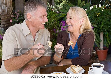 Stock Photo - Mature couple having cake. Fotosearch