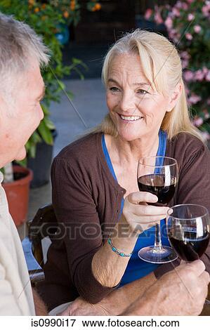 Mature couple having red wine View Large Photo Image Stock Photo - Mature couple having red wine. Fotosearch