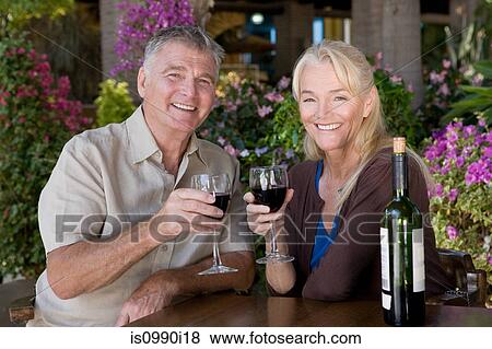 Stock Photo - Mature couple having red wine. Fotosearch