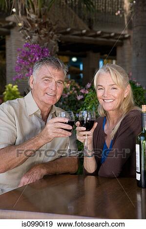 Stock Photo - Mature couple having red wine. Fotosearch