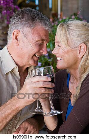 Mature couple having wine View Large Photo Image Stock Image - Mature couple having wine. Fotosearch