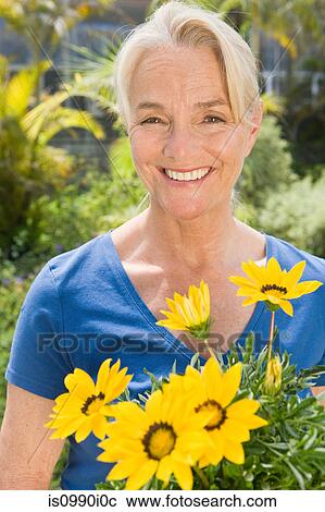 Stock Image - Woman with yellow flowers. Fotosearch