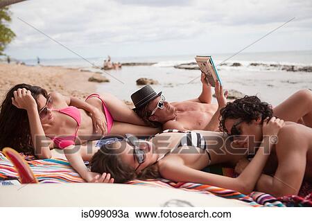 Four young friends on beach vacation View Large Photo Image Stock Image - Four young friends on beach vacation. Fotosearch