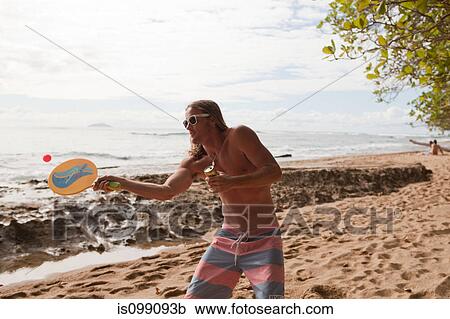 Man playing bat and ball game on beach View Large Photo Image Stock Image - Man playing bat and ball game on beach. Fotosearch