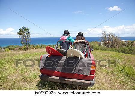 Off road vehicle driving toward beach with two women in back View Large Photo Image Picture - Off road vehicle driving toward beach with two women in back. Fotosearch
