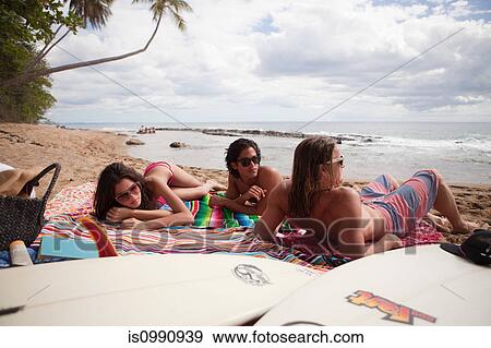 Three young friends on beach vacation View Large Photo Image Stock Photo - Three young friends on beach vacation. Fotosearch