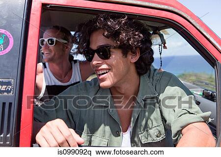 Two men looking out of open car window on vacation View Large Photo Image Stock Photography - Two men looking out of open car window on vacation. Fotosearch