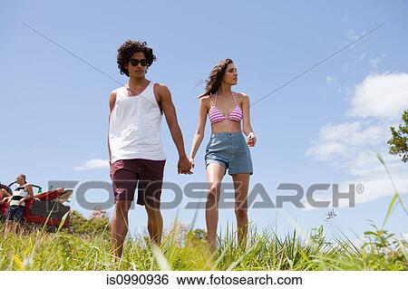Stock Photograph - Young couple holding hands. Fotosearch
