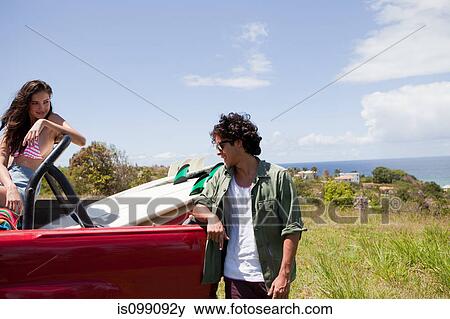 Young couple with surfboard in car View Large Photo Image Stock Photo - Young couple with surfboard in car. Fotosearch