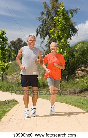 Mature couple jogging together View Large Photo Image Stock Image - Mature couple jogging together. Fotosearch