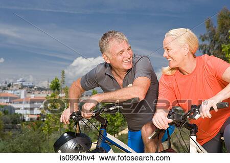 Picture - Mature couple on bicycles. Fotosearch