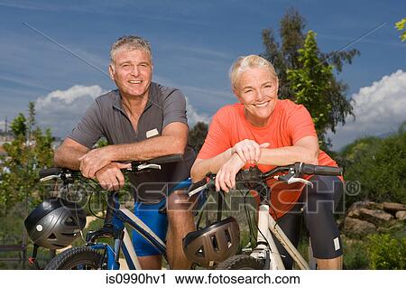 Mature couple on bicycles View Large Photo Image Stock Image - Mature couple on bicycles. Fotosearch
