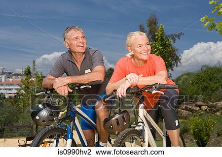 Mature couple on bicycles View Large Photo Image Stock Image - Mature couple on bicycles. Fotosearch