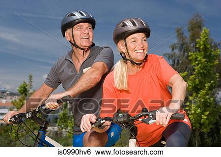 Stock Photograph - Mature couple on bicycles. Fotosearch