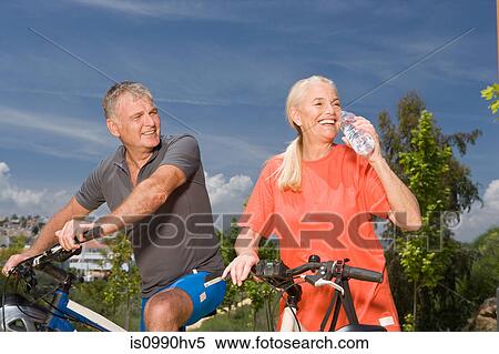 Mature couple on bicycles View Large Photo Image Stock Photography - Mature couple on bicycles. Fotosearch