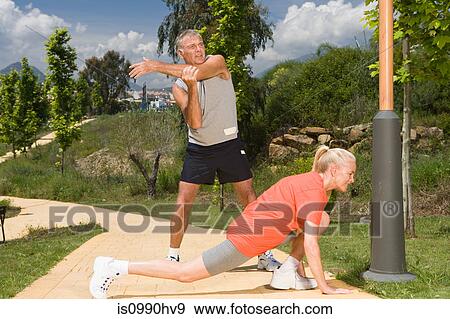 Stock Photo - Mature couple stretching before exercise. Fotosearch