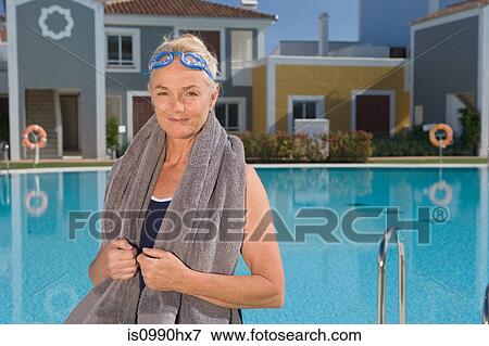 Mature woman by swimming pool with towel View Large Photo Image Stock Photo - Mature woman by swimming pool with towel. Fotosearch